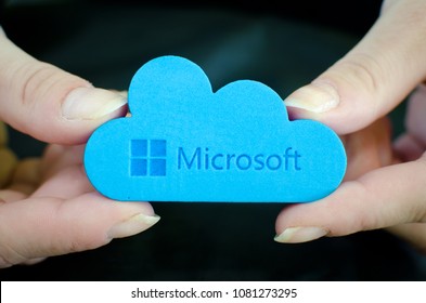 Nis, Serbia, April 24, 2018:  woman hands on black background  holding Microsoft Windows OneDrive icon