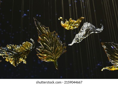 NITRA, SK - APRIL 27, 2022: Elements of decorative interior chandelier golden and transparent Swarovski crystals shaped like a leaves, made by LIDES company from Slovakia, displayed on Furniture Expo.