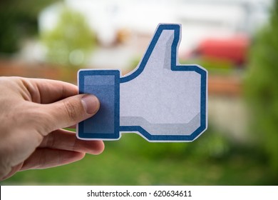 Nitra, Slovakia, April 11, 2017: Man Holding Facebook Like Button Printed On Paper