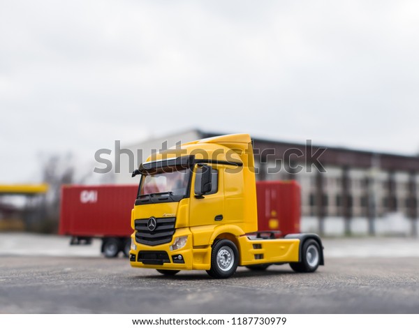 NITRA, SLOVAKIA - DECEMBER 26 2017: Scale model
Mercedes-Benz Actros with container trailer. Truck with trailer on
the road. Yellow truck.