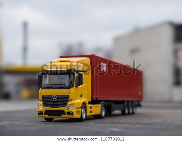 NITRA, SLOVAKIA - DECEMBER 26 2017: Scale model
Mercedes-Benz Actros with container trailer. Truck with trailer on
the road. Yellow truck.