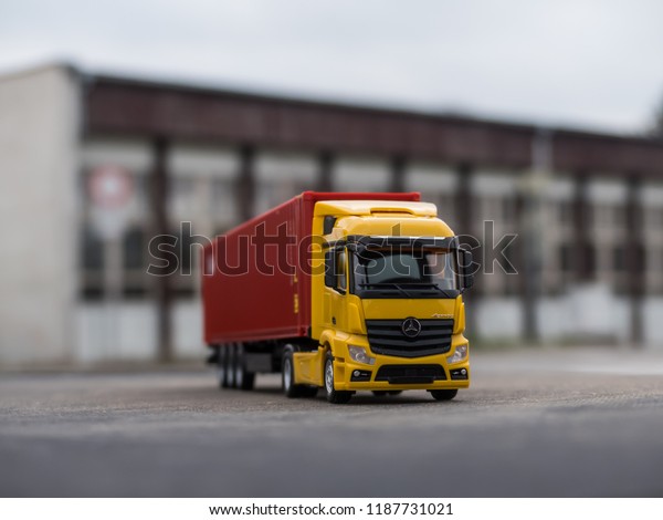 NITRA, SLOVAKIA - DECEMBER 26 2017: Scale model\
Mercedes-Benz Actros with container trailer. Truck with trailer on\
the road. Yellow truck.