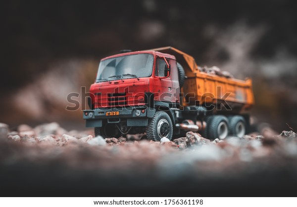 NITRA, SLOVAKIA - MAY\
25 2020: Travelling Red Tipper truck Tatra 815 S1 with heavy load.\
Scale model Tatra. Scale model 1:43. Red - yellow dumper. Old truck\
with rock load.