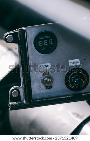 Nitro button on the dashboard of a racing car to increase engine power, nitro switch, nitro power, extra engine power