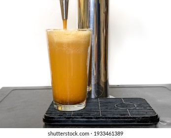 Nitro Cold Brew Coffee Pouring Into A Clear Glass With Fine Nitrogen Bubbles And A Smooth Texture On A Keg Coffee Dispenser.