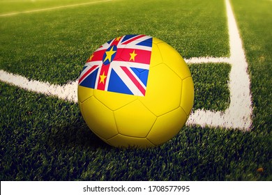 Niue flag on ball at corner kick position, soccer field background. National football theme on green grass. - Powered by Shutterstock