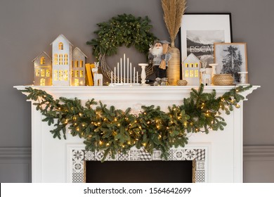 Nizhniy Novgorod, Russia - November 8, 2019: Photo studio 2.8. Fireplace with christmas decorations standing on it and fir branches and garlands hanging on it