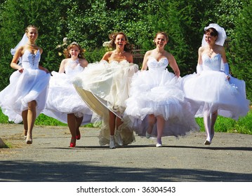 NIZHNIY TAGIL, RUSSIA - AUGUST 09: Group Of Happy Excited Brides Running At Parade Of Brides August 09, 2009 In Nizhniy Tagil