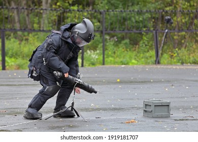 NIZHNY TAGIL, RUSSIA - AUG 21, 2012: Anti-terrorist exercises at the exhibition RUSSIAN DEFENCE EXPO 2012. A sapper in an explosion-proof suit installs a device for remote destruction of explosives