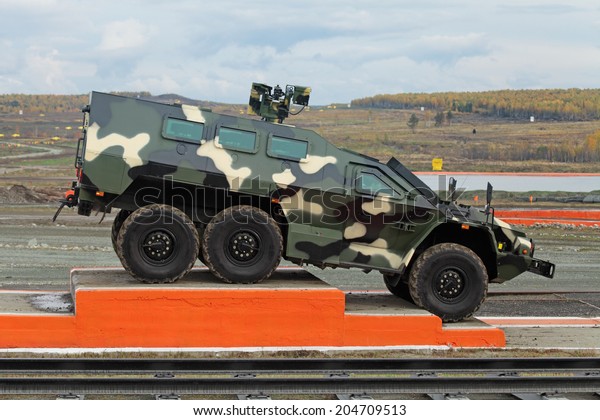 NIZHNY TAGIL, RUSSIA - SEP 26, 2013: The international\
exhibition of armament, military equipment and ammunition RUSSIA\
ARMS EXPO (RAE-2013). The russian armored car \
