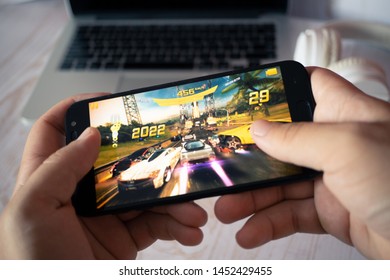 Nizhyn, Ukraine/July-16-2019: Hands holding smartphone and playing Asphalt 8 Airborne. Android gaming concept. - Shutterstock ID 1452429455