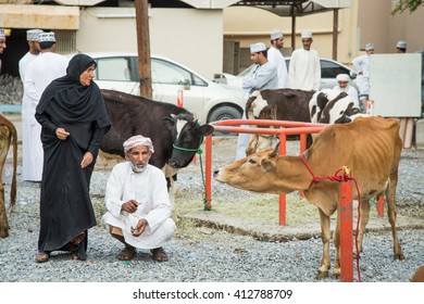 NIZWA, OMAN - CIRCA MARCH 2016: Old Omani Couple Selling Their Cows