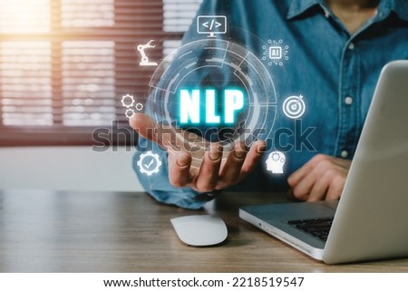NLP natural language processing cognitive computing technology concept, Business person hand holding VR screen NLP icon on office desk, AI Artificial intelligence.