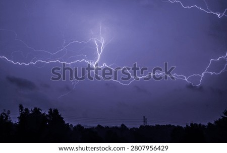 No AI. Big flash of lightning across the night sky.