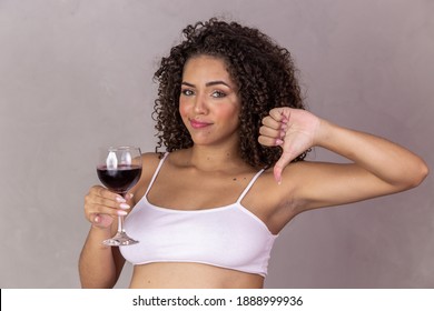No alcohol during pregnancy. Pregnant young woman making negative sign with glass of wine
