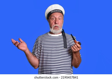 no answer - image. An old sailor with a confused look. Smoking pipe, marine uniform. on a blue background isolated