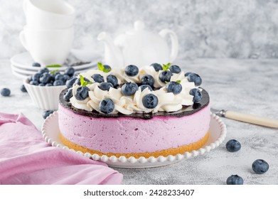 No baked blueberry cheesecake with berry jelly, whipped cream and fresh blueberries on top. Selective focus, copy space - Powered by Shutterstock