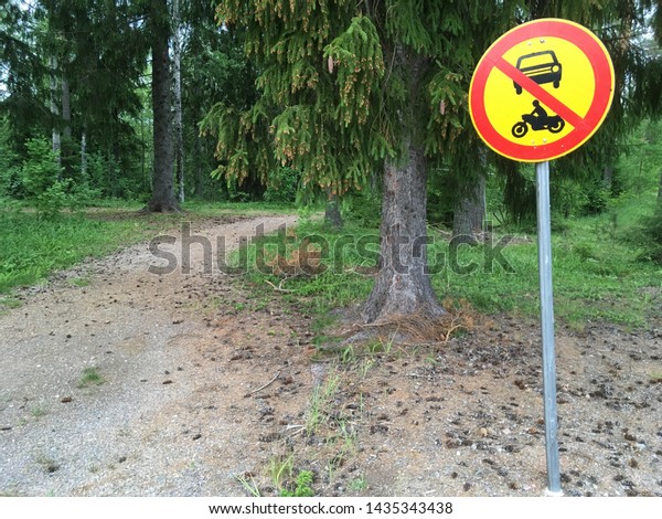 No car and motorbike road sign in the forest park on the\
walking path. 