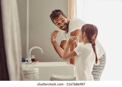 No cavities for this family. Shot of a happy father and his little girl washing their hands together in the bathroom. - Powered by Shutterstock