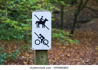 No Cycling, No Horse Riding Signpost In A Forest