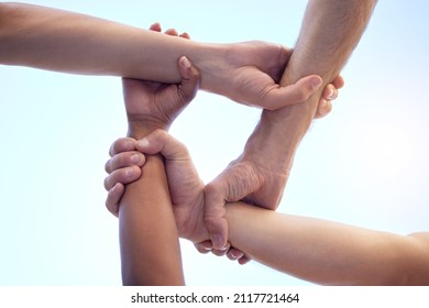 No Discrimination Between Our Team. Shot Of A Group Of Diverse People With Their Arms Interlinked.