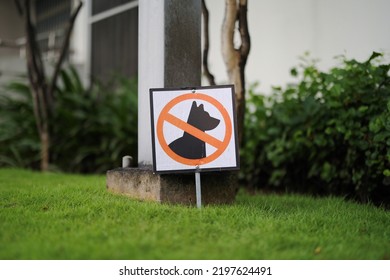 No Dogs Allowed Sign On Grass At Outdoor Common Area