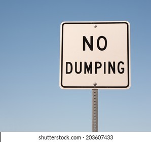 No Dumping Sign And Blue Sky.