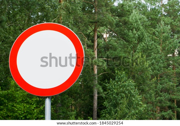 No entry road sign. Private\
property road with traffic forbidden. Do not drive in information.\
Entrany restrictions background. Car traffic banned in\
forest.