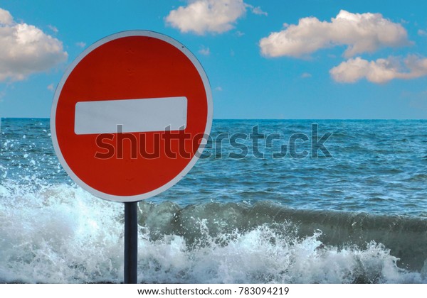 A no entry sign forbidden on the background of the\
sea or lake. Prohibited access to the shore. no swimming. Denied\
access to water.