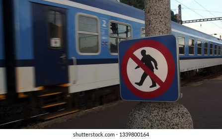 No Entry Sign And Moving Train – No Trespassing Sign At The Train Station In Prague – Czech Republic. Railroad Station Signs.