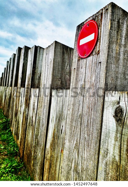 No entry sign on\
wooden block barrier