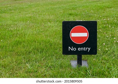 No entry sign standing on grass. No people. Copy space left. - Shutterstock ID 2015809505