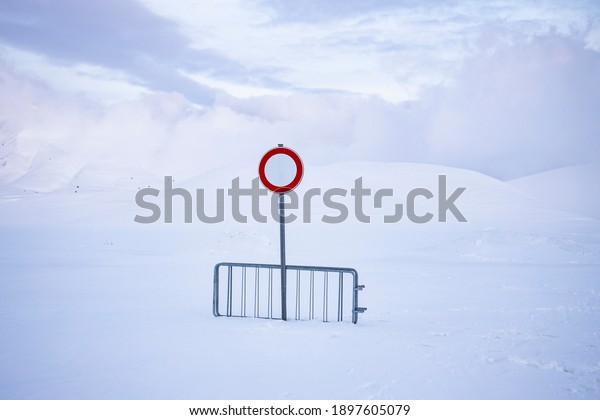 \
no\
entry or transit, on a snow-covered road, over one meter of snow.\
desolation and silence in an abandoned\
landscape.