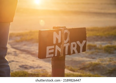 No Entry Wooden Rustic Sign On A Lawn  At Sunset