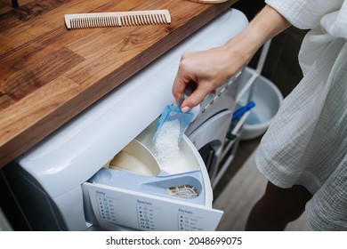 No Face Image Of A Woman Pouring Powder In A Washer. High Angle