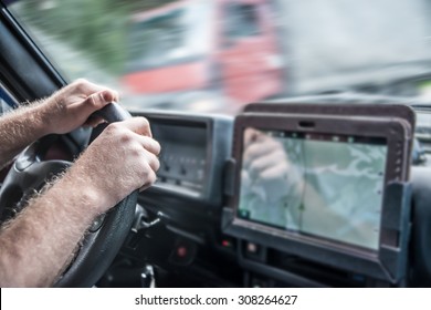 No Face Unrecognizable Person Man Holding Mobile Phone With Gps Application In The Car With Tablet Screen Computer Sun Light On Finger Sunset Rays On Hands Male Inside Brutal SUV Car Against Truck 