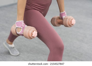 No Face Visible. Athletic Young Woman Doing Heavy Lifting Using Dumbbell At The Gym. Young Woman Exercise Using Dumbbell To Lose Weight Or Burn Calories.