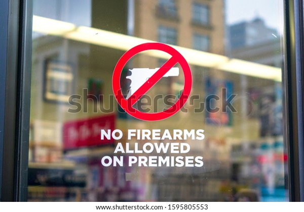No\
firearms allowed on premises sign on the glass entrance door to\
establishment notifies patrons that weapons aren\'t allowed,\
addresses security policy and protection\
concerns.