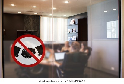 No Handshake Concept, Changing Greetings Habits, Sign At The Entrance Of A Meeting Room With Employees Having A Meeting In A Company