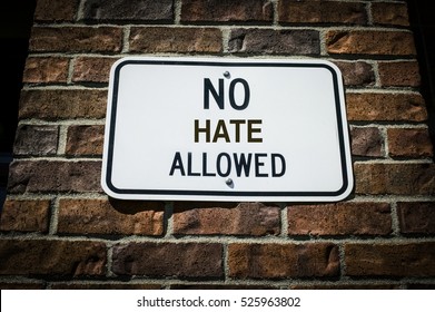 No Hate Allowed Sign On A Brick Wall