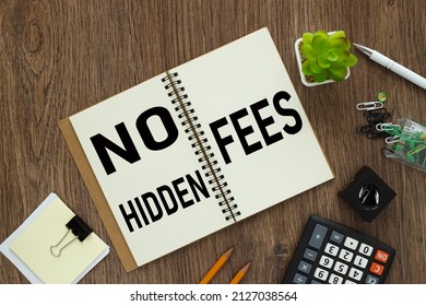 No hidden fees. text on an open notepad. on a wooden work table