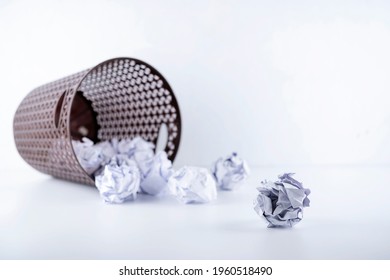 No idea - Crumpled paper can recycle was thrown to metal basket bin. Overflowing waste paper in office garbage bin. Junk, wastepaper in rubbish isolated on white background