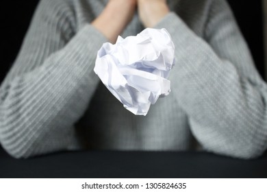 No idea and fail concept. Crumpled paper in the form of balls hangs up hand,  as metaphor for inability to express or creativity crisis.  it does not work out, a lot of stress and anxiety. - Shutterstock ID 1305824635
