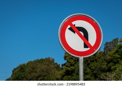 No left turn sign against blue sky. Traffic signs. Prohibited from turning left.  - Shutterstock ID 2198895483
