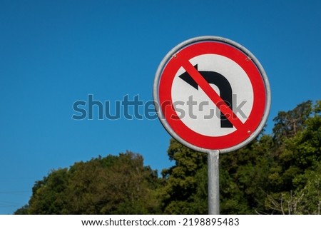 No left turn sign against blue sky. Traffic signs. Prohibited from turning left. 