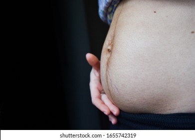 no longer pregnant woman holding her belly