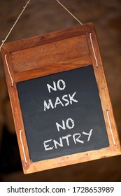 No Mask No Entry Coronavirus COVID-19 Wooden Blackboard Or Chalkboard Menu Sign Hanging In A Retail Shop, Restaurant Or Cafe