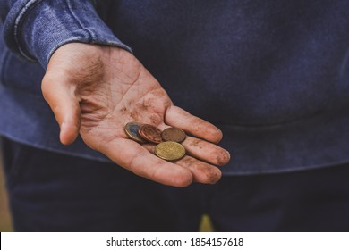 No Money Concept. Hand Asking For Money. Poor Man Begging For Money. Dirty Hand Holding Euro Coins.