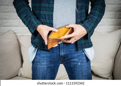 No Money Concept, Man Holding Hand On The Empty Brown Wallet And Empty Pocket Jean.