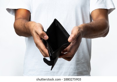 No Money. Unrecognizable Unemployed Black Man Showing Empty Wallet Standing Over White Studio Background. Bankruptcy, Unemployment And Poverty, Financial Crisis Concept. Cropped, Closeup